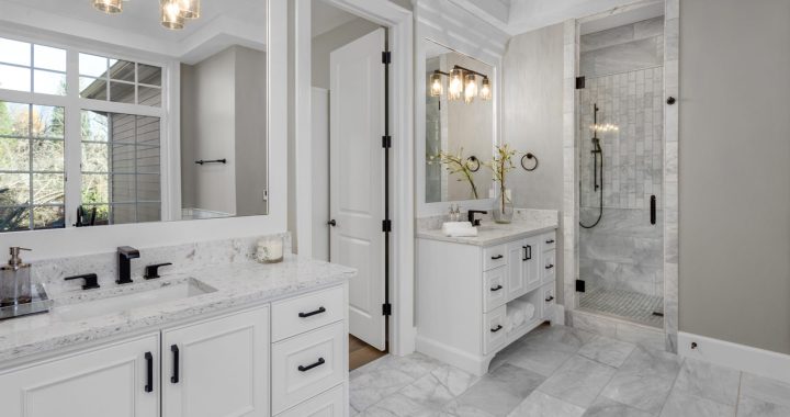 A luxury master bathroom with marble countertop, flooring, shower backsplash