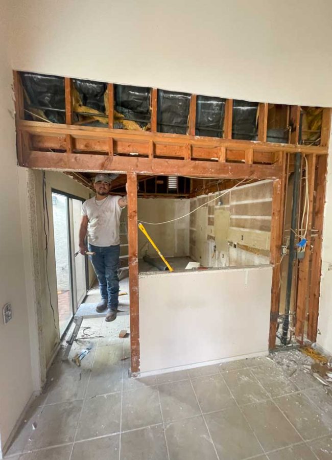 A skilled remodeler inside a house that is undergoing renovation